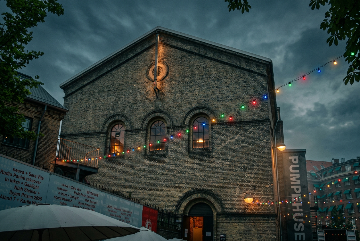 Brick gable of Pumpehuset with three arched windows and string lights